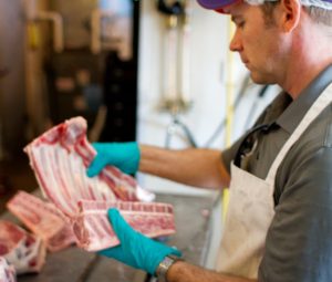 Executive chef Jason Gibbons reviewing rack of lamb