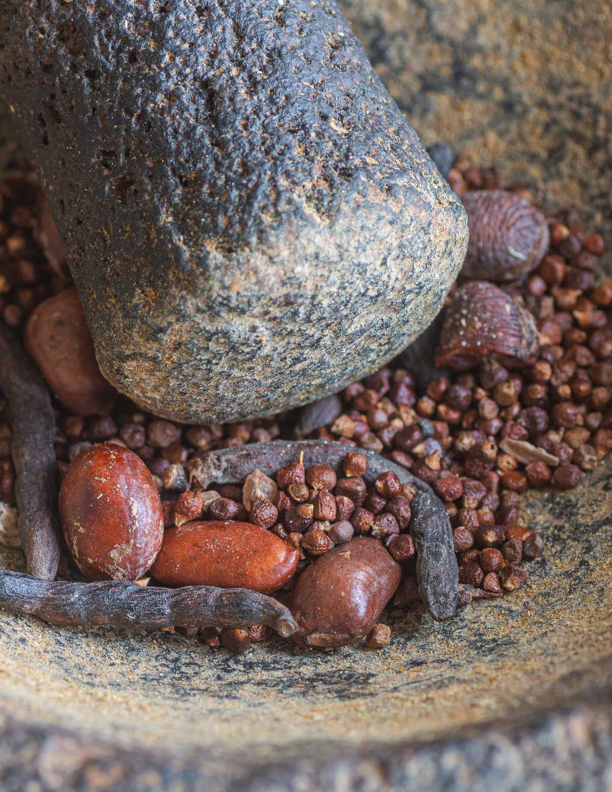 Grinding fresh pepper soup spices.