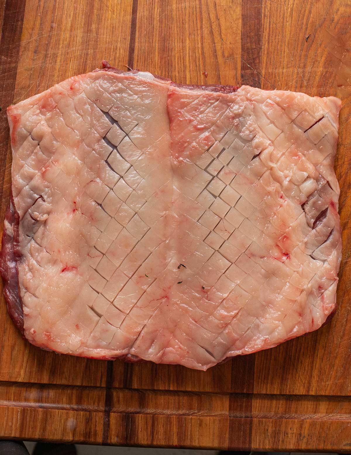 A lamb saddle showing cut, scored fat.