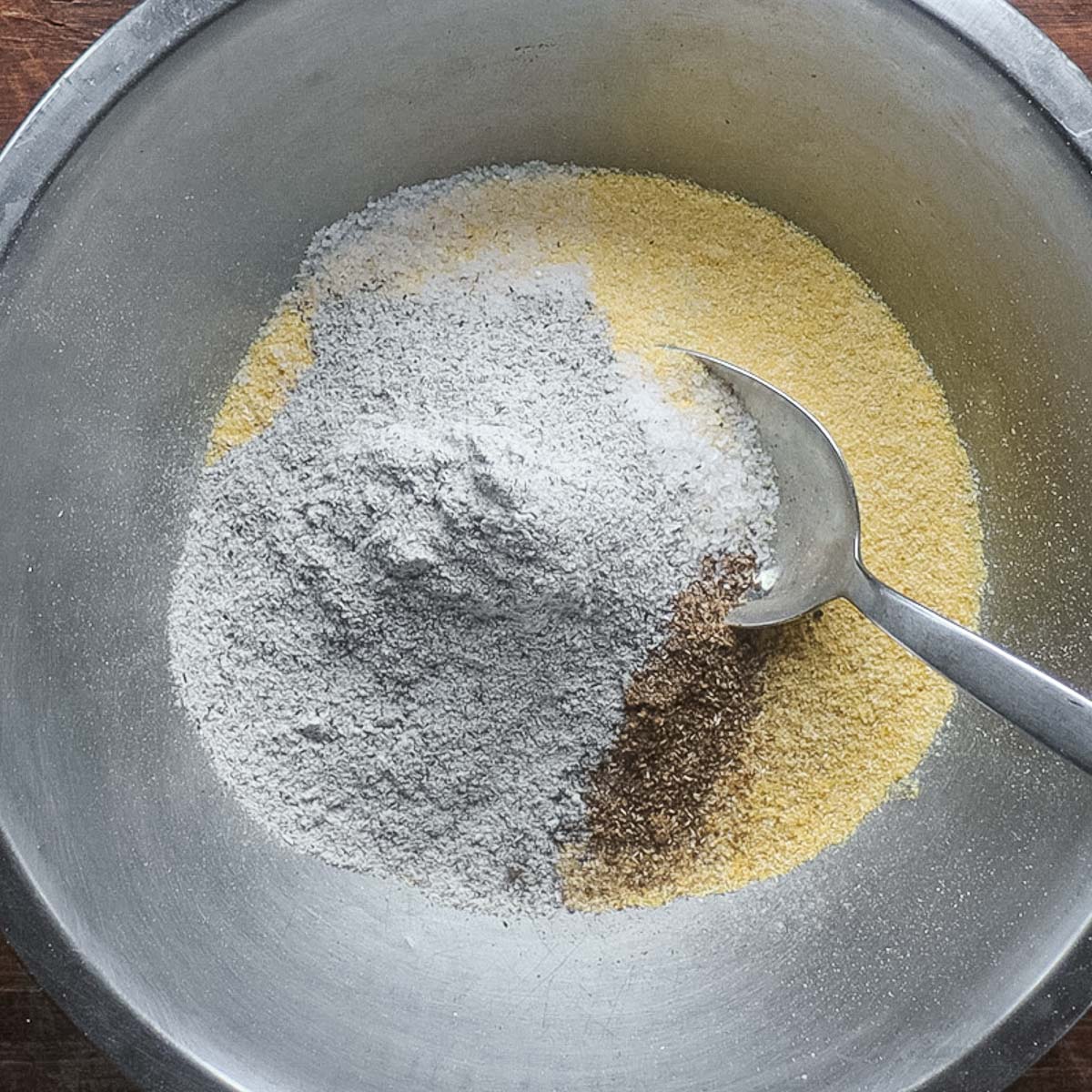 Mixing cornmeal, spices and buckwheat flour.