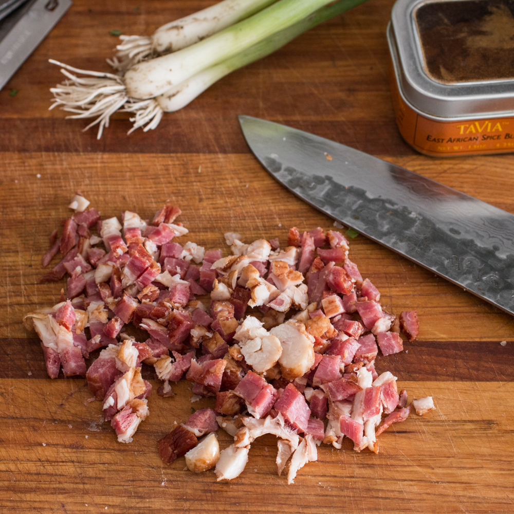 Dicing goat bacon to add to meatloaf.