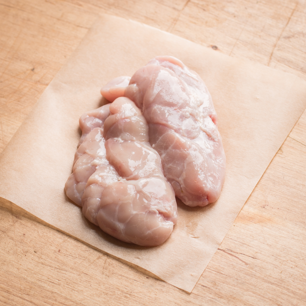 Raw lamb sweetbreads on a piece of parchment ready to cook.