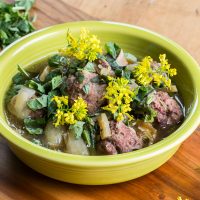 Grassfed lamb or goat meatball stew recipe with greens and fava beans