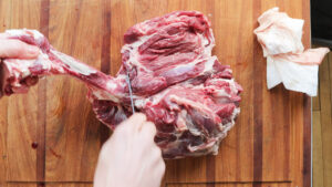Cutting a lamb leg into roasts