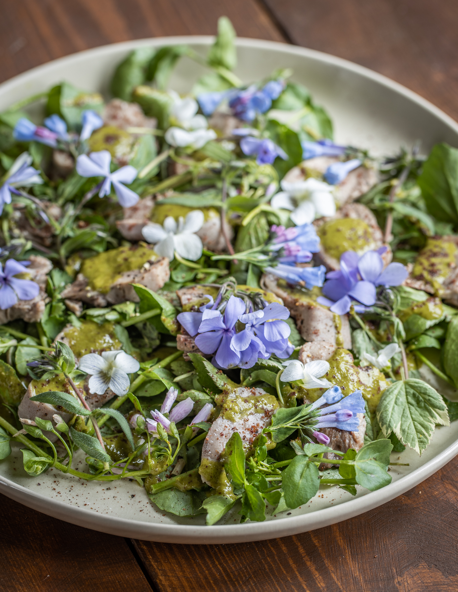 Goat tongue salad with salsa verde, fresh greens and wildflowers