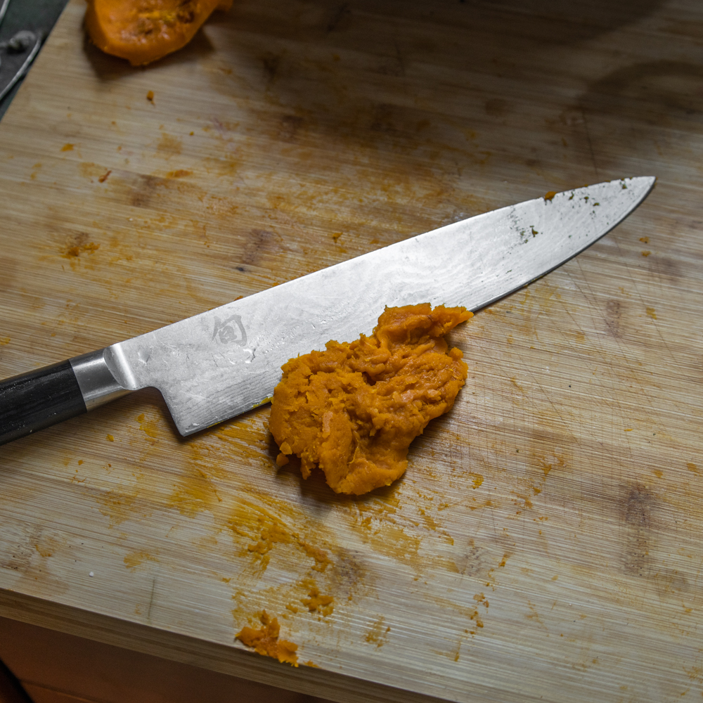 Chopping cooked squash for lamb hand pies