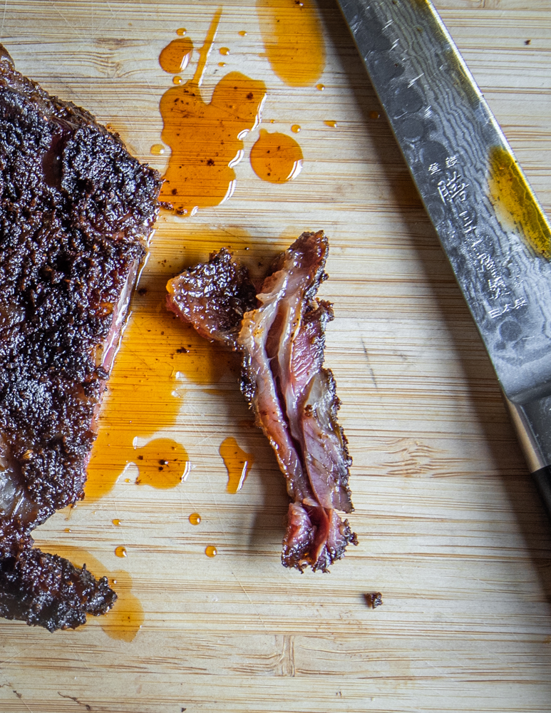 Cutting dry-rubbed lamb breast