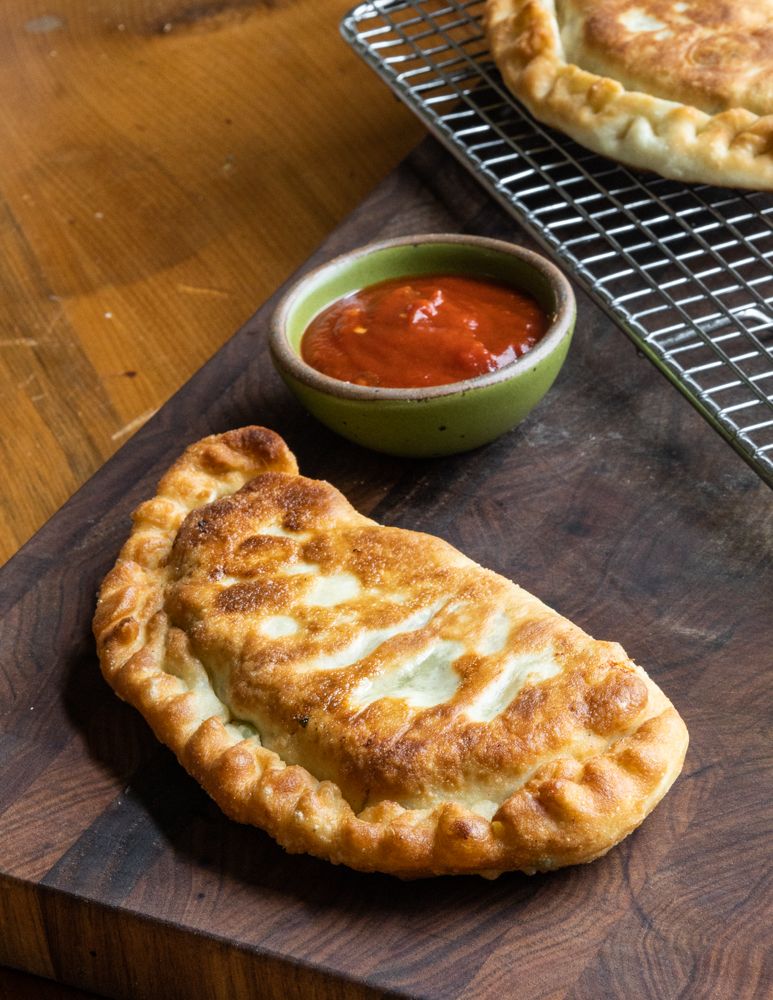 lamb or goat sausage calzones with spicy tomato sauce 