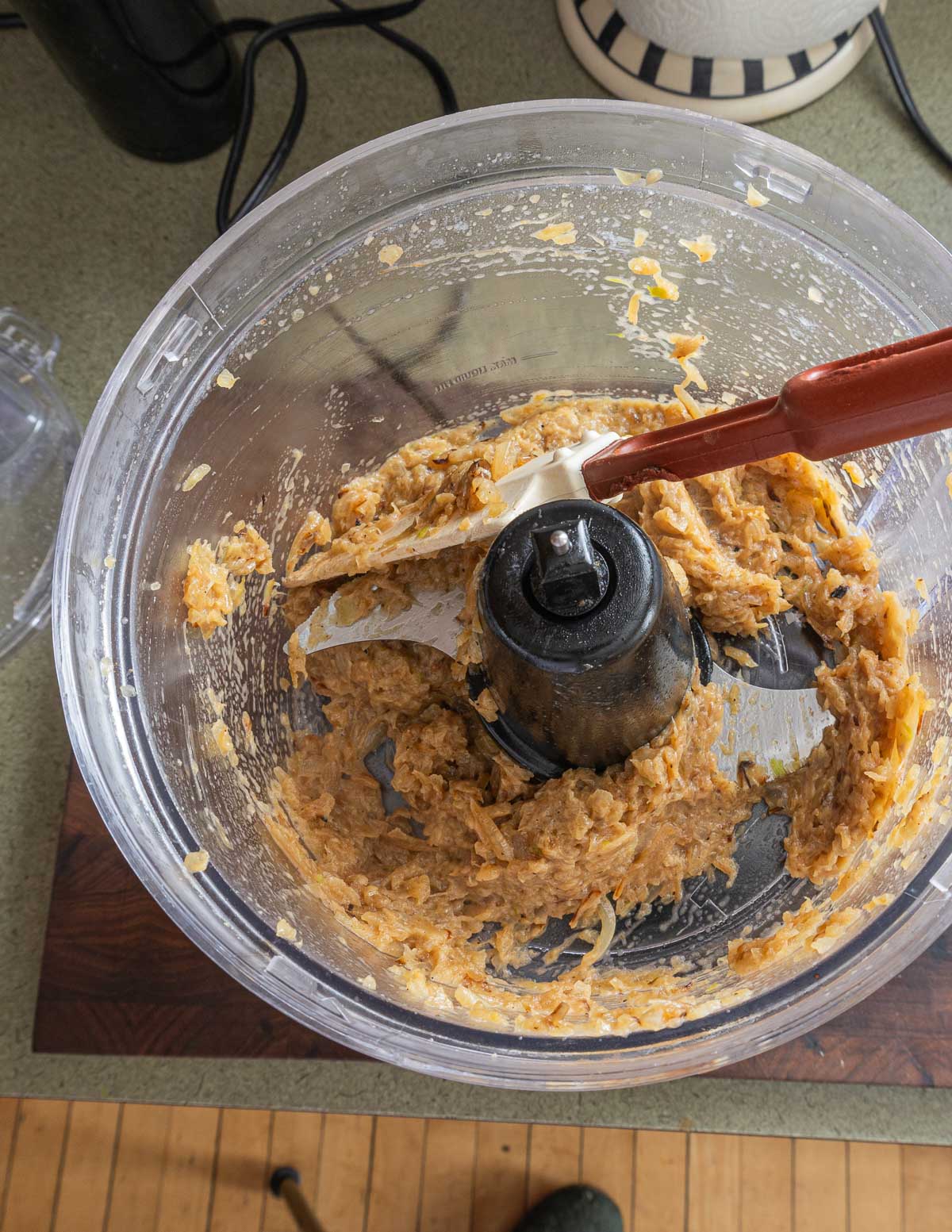 Pureeing caramelized onions in a food processor.