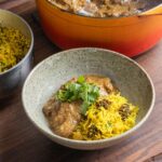 A bowl of mutton korma with Indian mushroom rice.