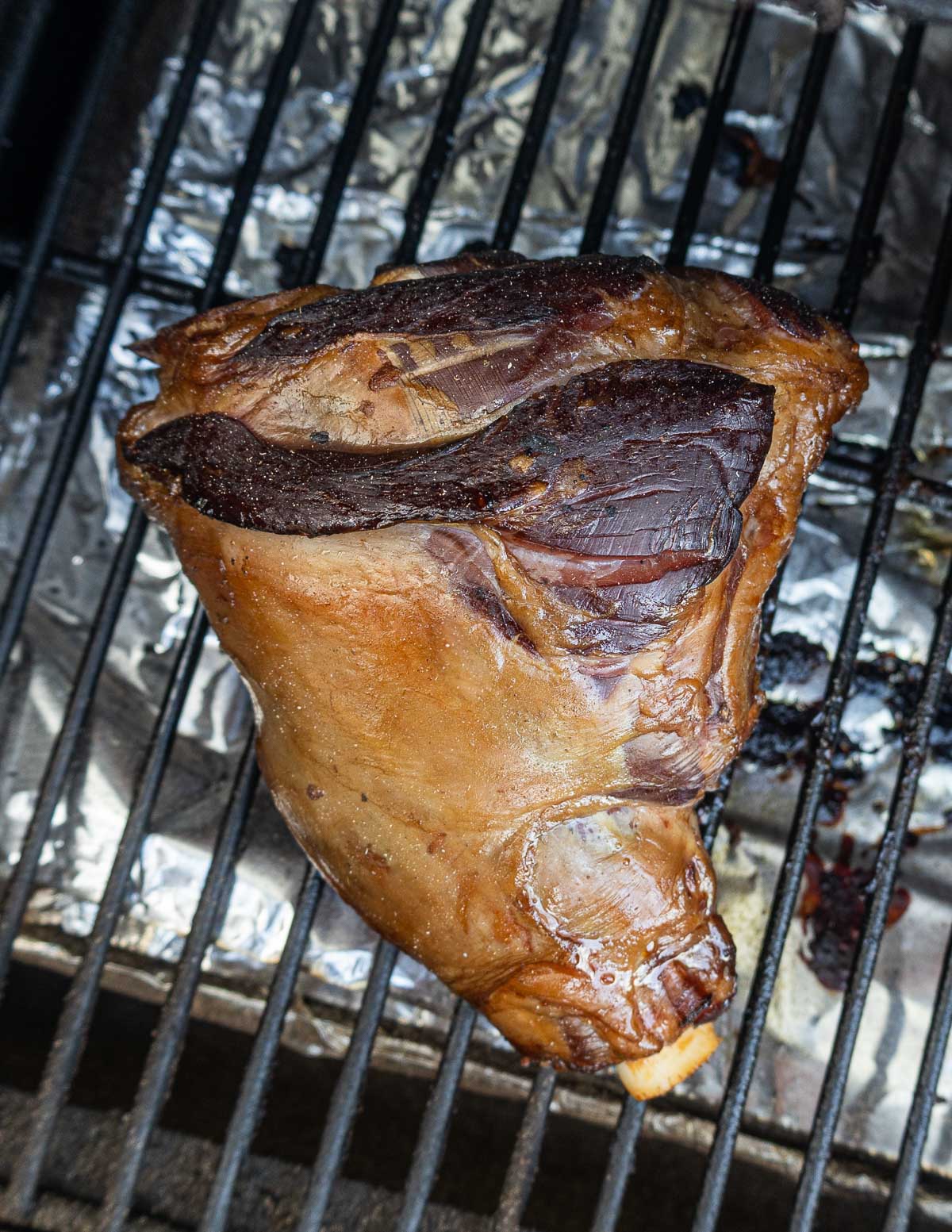 Close up image of a smoked lamb shank in the smoker.